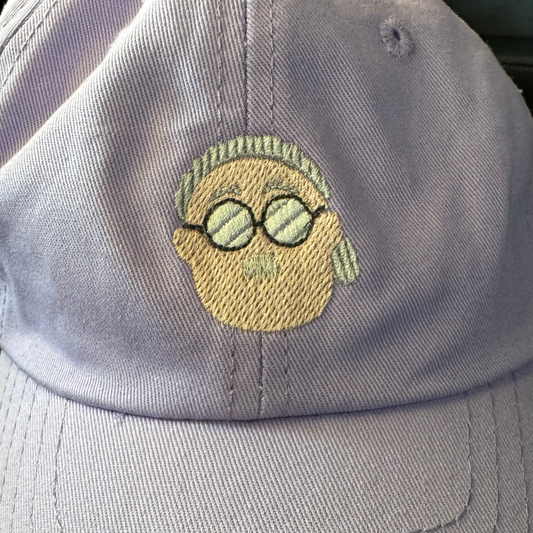 Dad cap with embroidered design of an anime face wearing glasses days